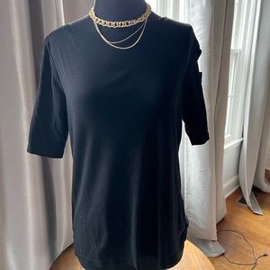 Black knit top with checkboard cut out on sleeves.